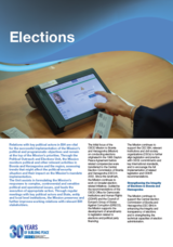 Touchscreen voting machine on a wooden table, hand interacting with it, text columns below, blue header saying "Elections".