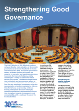 Conference hall with circular seating, vibrant colors, and a blue header with "Strengthening Good Governance."