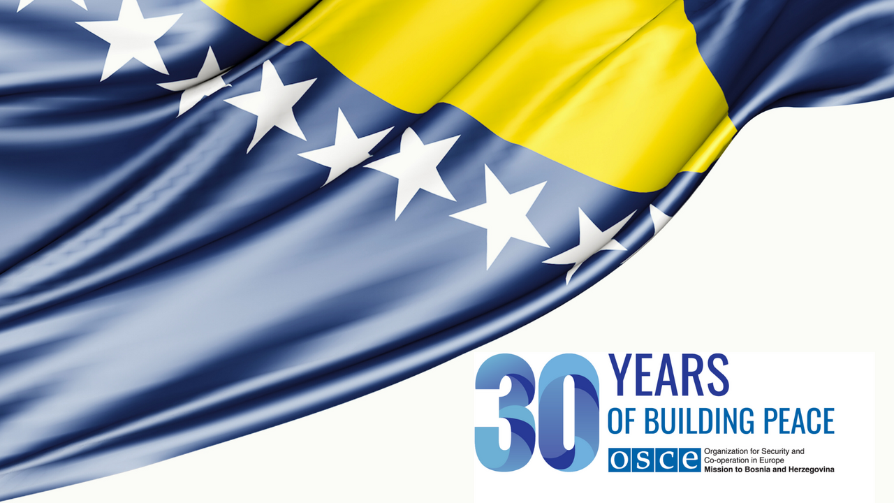 Bosnia and Herzegovina flag with the text "30 Years of Building Peace" beside it.